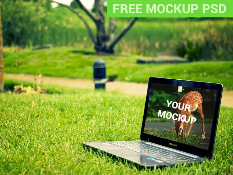 laptop on green grass mockup psd notebook